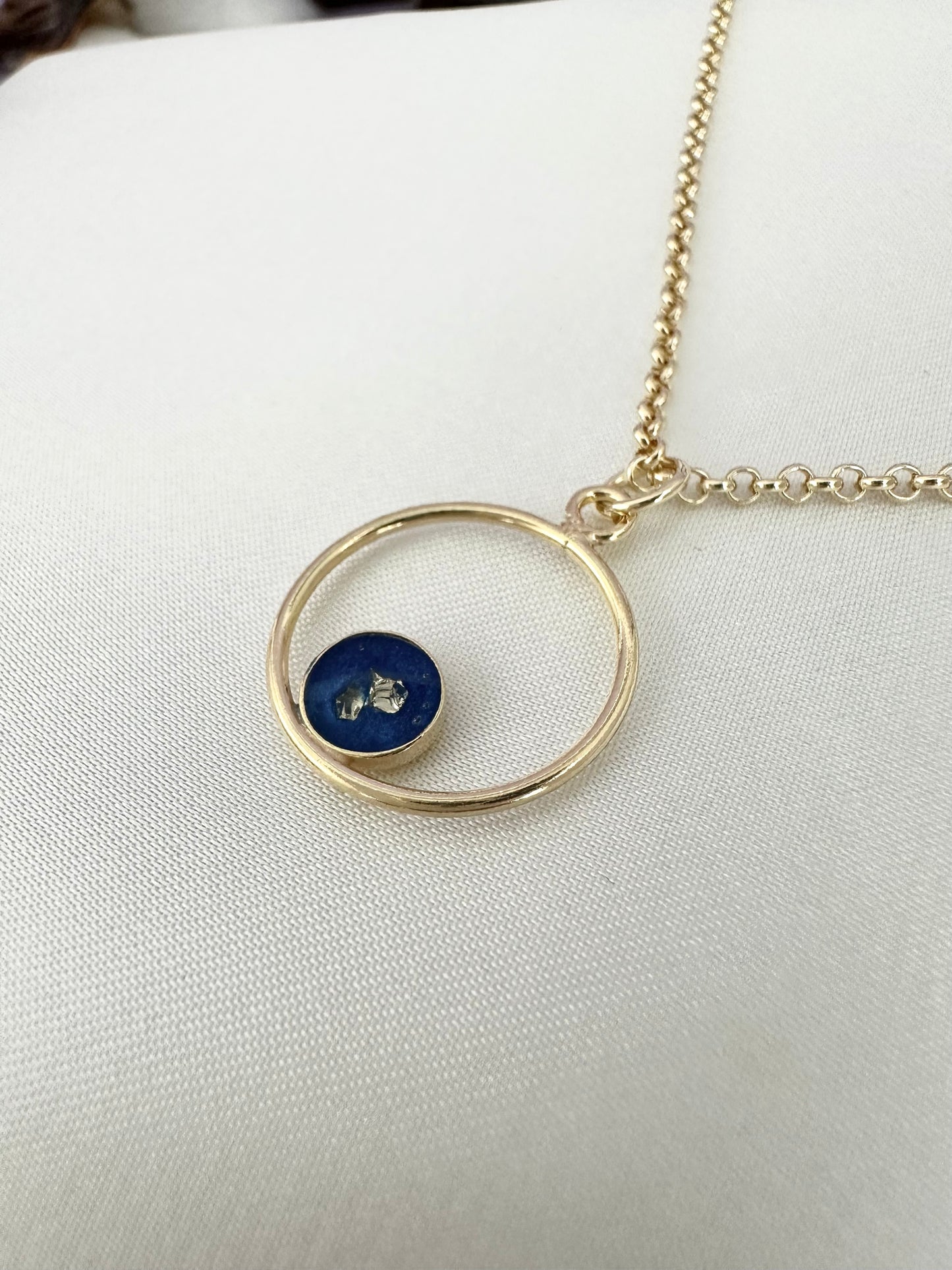 Necklace with blue pendant and golden stones